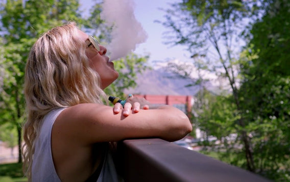 Woman in field vaping Hemplucid CBD