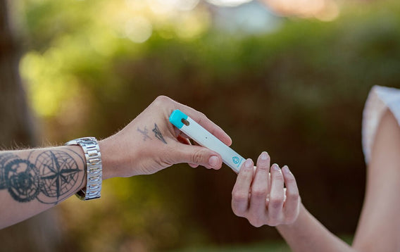 two hands passing delta 8 hemp vape pod