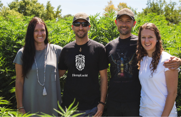 group of 4 hemplucid founders standing in front of a hemp farm outside 